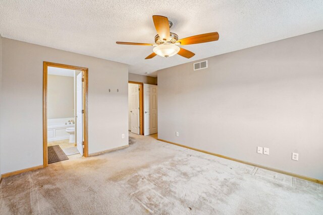 unfurnished bedroom with visible vents, light carpet, baseboards, and a textured ceiling