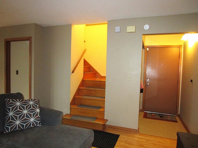 stairway featuring wood finished floors and baseboards