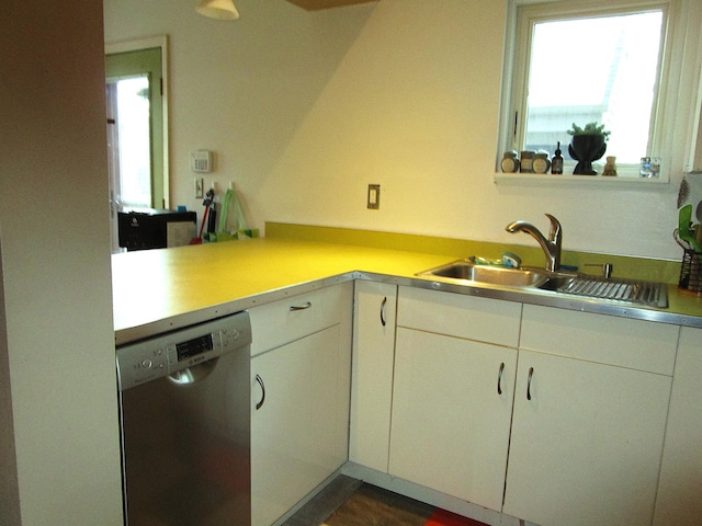 kitchen featuring a sink, white cabinets, dishwasher, and light countertops