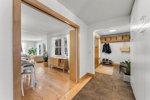 hallway featuring dark wood-type flooring and a textured ceiling