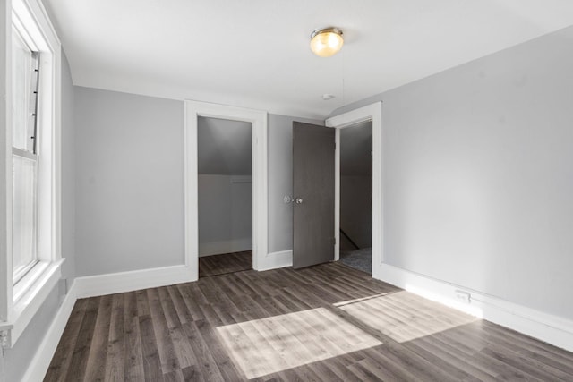 unfurnished bedroom featuring dark wood-type flooring and a closet