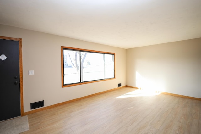 interior space with visible vents, light wood-type flooring, and baseboards