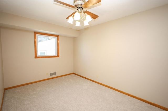 unfurnished room with visible vents, ceiling fan, baseboards, and carpet