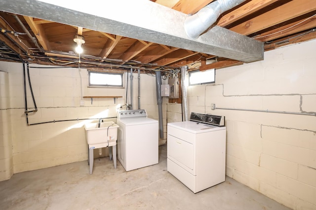 laundry area with washer and clothes dryer, electric panel, laundry area, plenty of natural light, and a sink