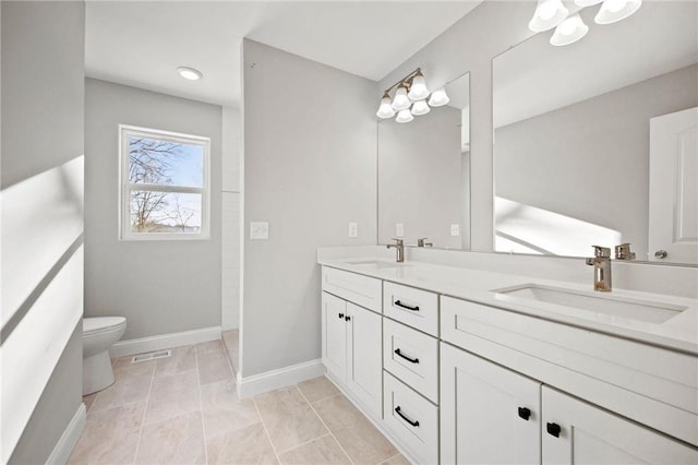 bathroom featuring vanity, toilet, and tile patterned flooring