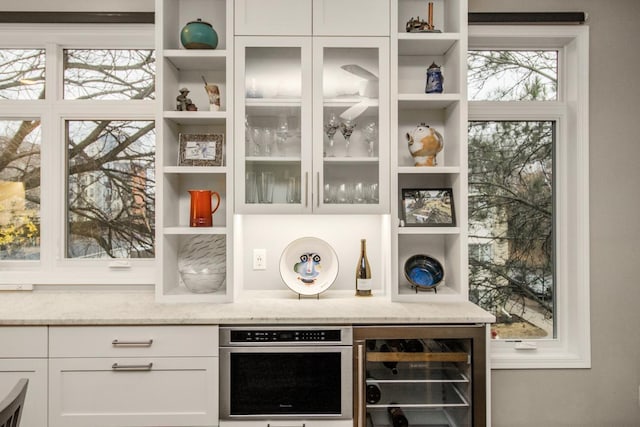 interior space featuring a wealth of natural light, wine cooler, and built in shelves