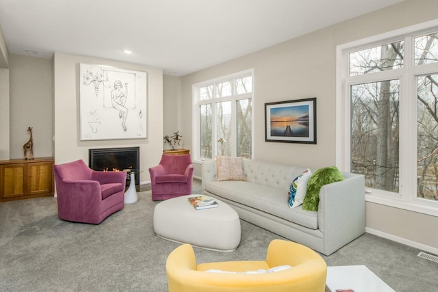 living area with visible vents, baseboards, a lit fireplace, carpet flooring, and recessed lighting