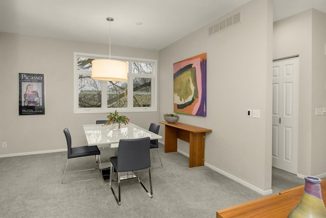 dining room with visible vents, carpet floors, and baseboards