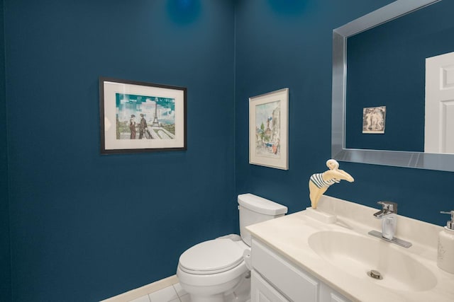 half bath featuring tile patterned flooring, toilet, vanity, and baseboards