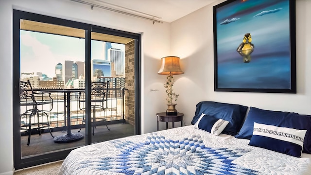 bedroom with access to outside and a city view