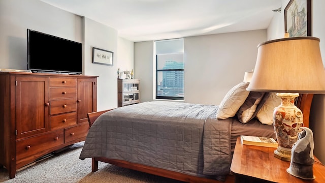 bedroom featuring light colored carpet