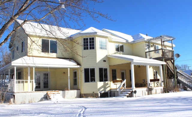 snow covered house with a porch