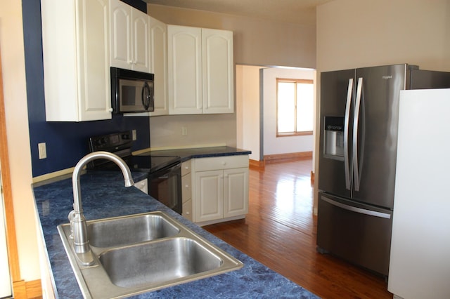 kitchen with sink, dark wood-type flooring, black appliances, and white cabinets