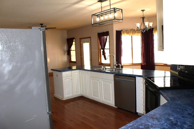 kitchen with sink, dishwasher, refrigerator, black electric range, and decorative light fixtures