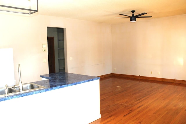 kitchen with hardwood / wood-style flooring, sink, and ceiling fan