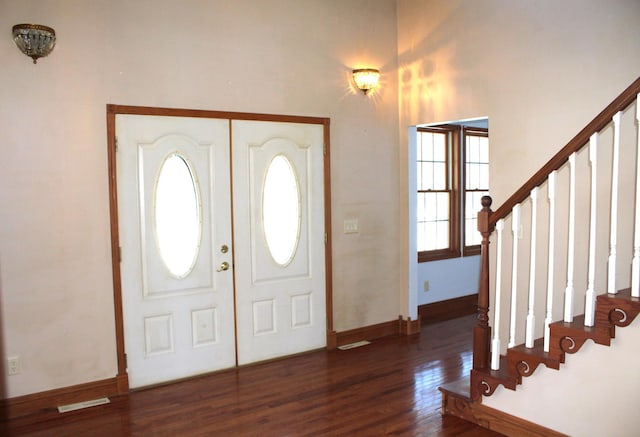 entryway with dark hardwood / wood-style flooring