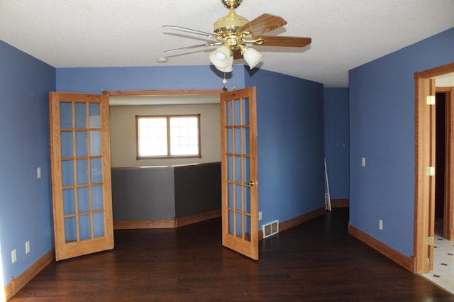 unfurnished room featuring ceiling fan and dark hardwood / wood-style flooring