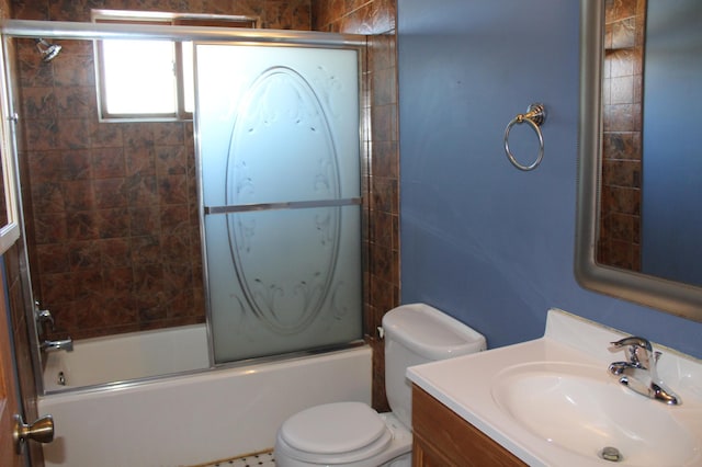 full bathroom featuring vanity, bath / shower combo with glass door, and toilet