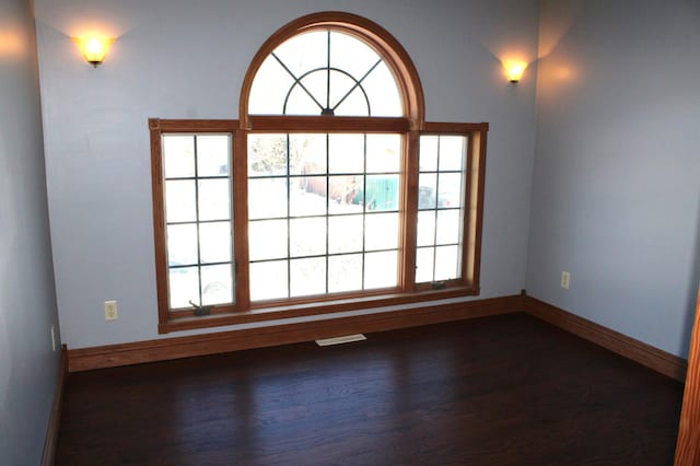 unfurnished room featuring dark wood-type flooring