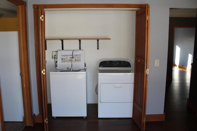 laundry room with dark hardwood / wood-style flooring and washer and clothes dryer