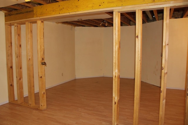 basement with hardwood / wood-style flooring