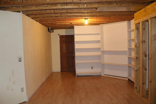 basement with hardwood / wood-style floors