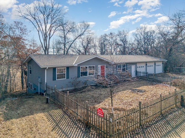 ranch-style home with fence and a garage