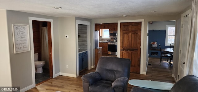 living area featuring a textured ceiling and light wood-type flooring