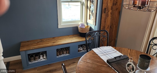 dining space featuring dark wood-type flooring and a notable chandelier