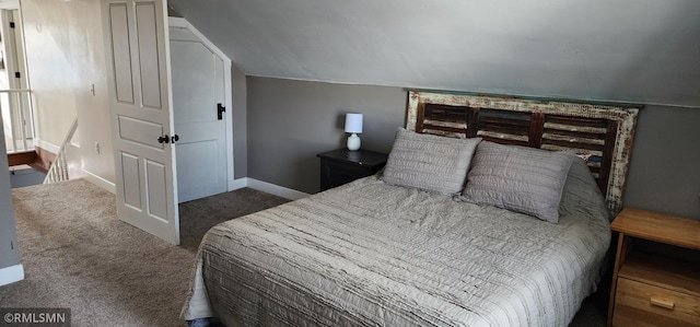 carpeted bedroom featuring lofted ceiling