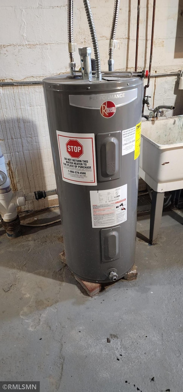 utility room with sink and water heater