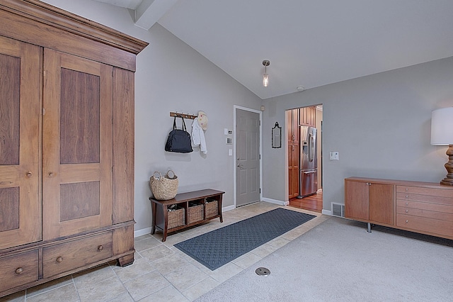 entrance foyer featuring lofted ceiling with beams