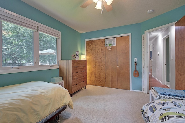 bedroom featuring carpet, ceiling fan, and a closet