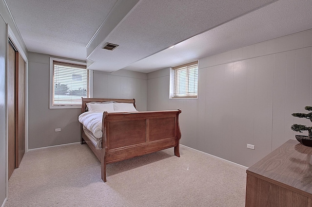 carpeted bedroom featuring a textured ceiling