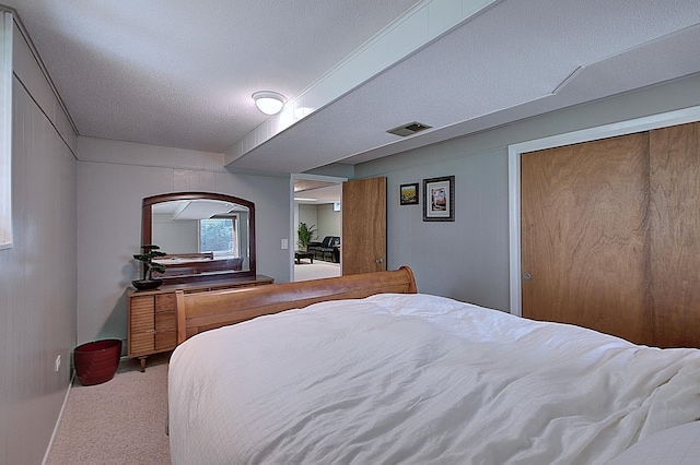 carpeted bedroom featuring a textured ceiling