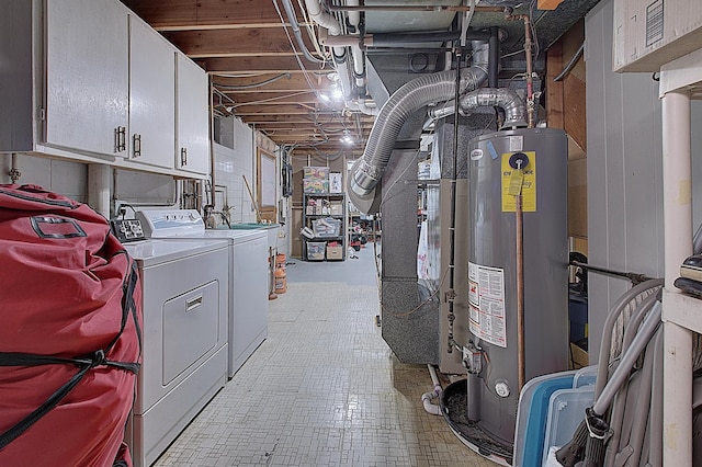 basement with washing machine and clothes dryer and gas water heater