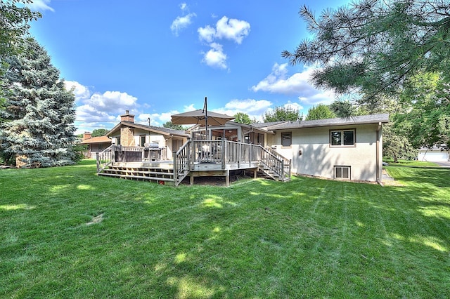 back of house featuring a deck and a lawn