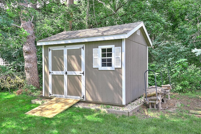 view of outdoor structure featuring a lawn