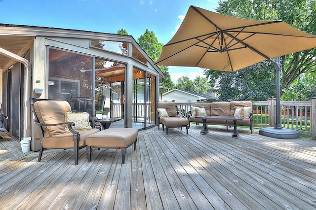 wooden deck featuring a sunroom and outdoor lounge area