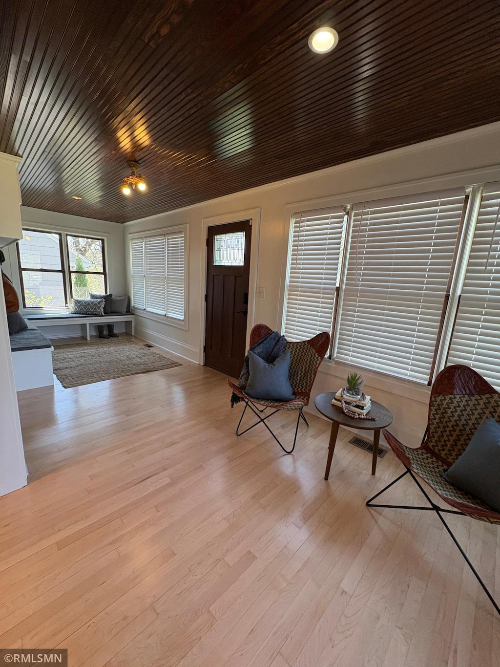 entrance foyer featuring plenty of natural light, wood finished floors, and wood ceiling