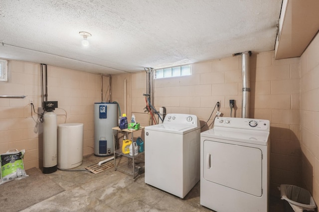 laundry area with washer and clothes dryer, electric water heater, and a textured ceiling