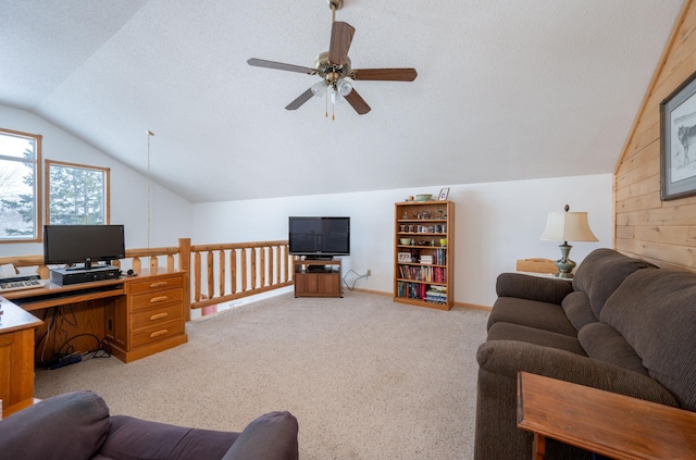 carpeted living room with ceiling fan, lofted ceiling, and a textured ceiling