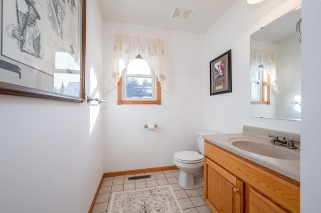 bathroom featuring vanity, tile patterned floors, and toilet