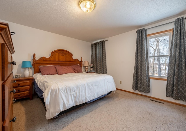 carpeted bedroom featuring a textured ceiling