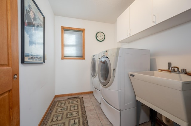 washroom with cabinets, independent washer and dryer, sink, and light tile patterned floors