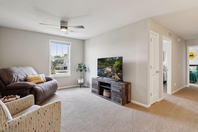 living room with carpet flooring, visible vents, and baseboards