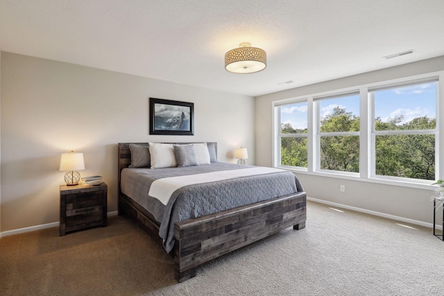 carpeted bedroom with visible vents and baseboards