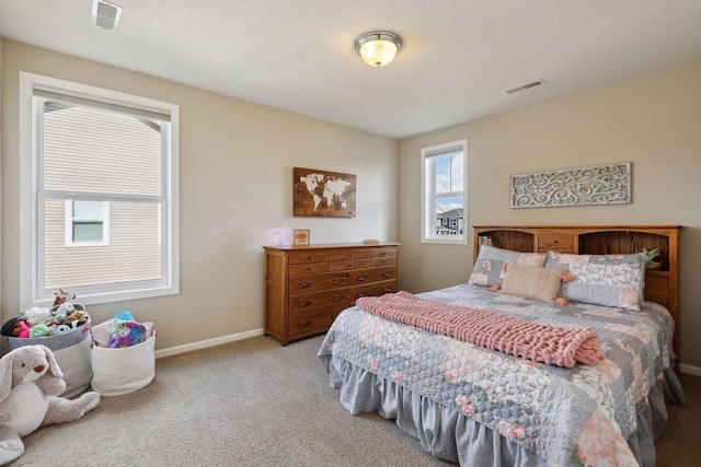 carpeted bedroom featuring visible vents and baseboards