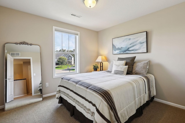 carpeted bedroom featuring baseboards and visible vents