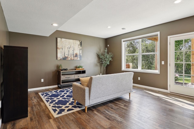 living area featuring a textured ceiling, hardwood / wood-style floors, recessed lighting, and baseboards